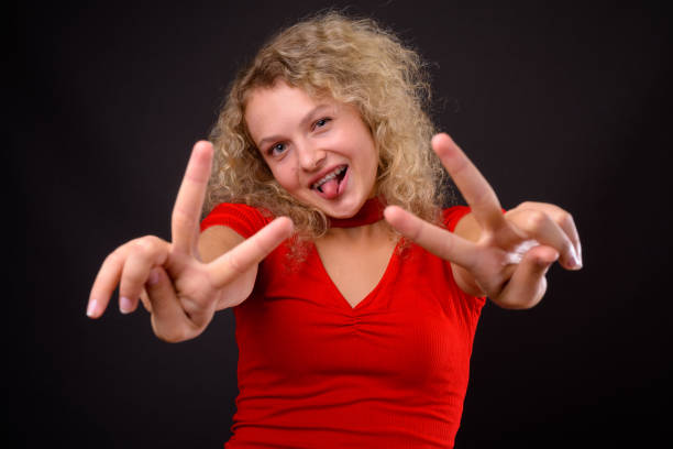 Energetic learner in a red top making peace signs